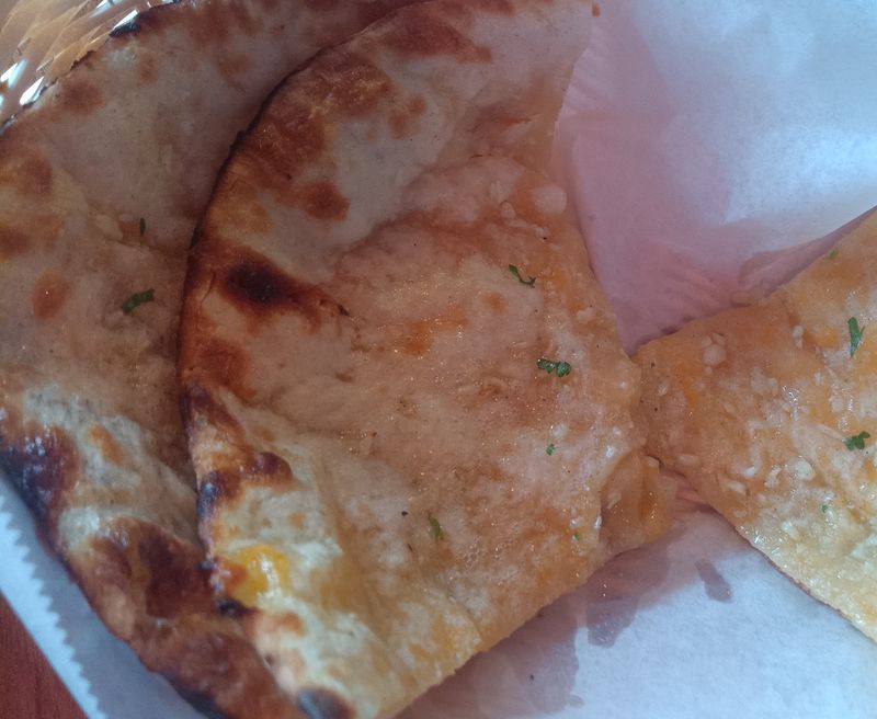 Cheese naan on a plate.