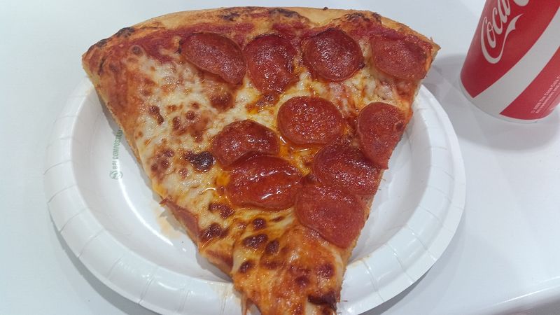 Photo of a greasy pizza with pepperoni and cheese.